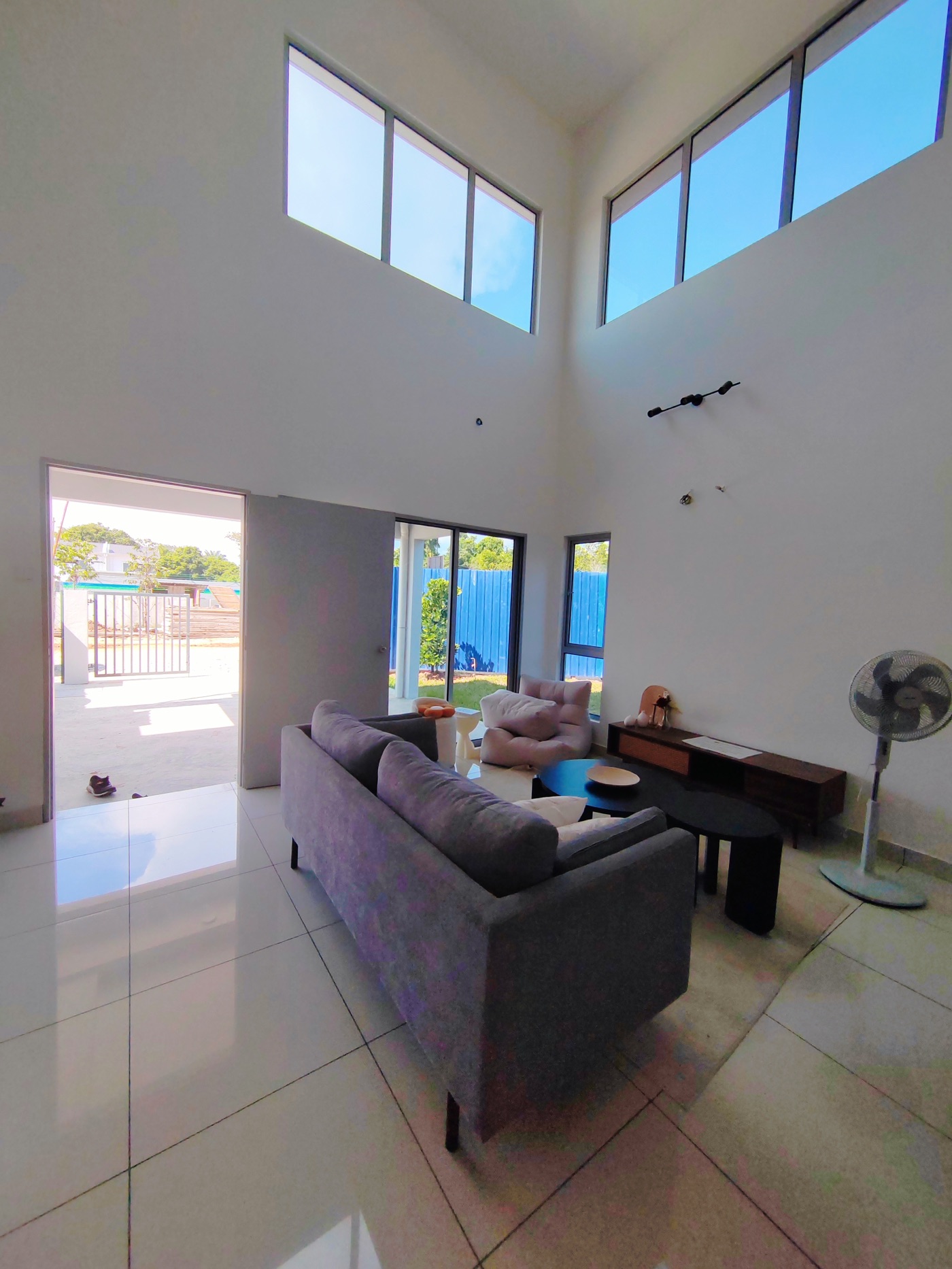 Foto ruang tamu rumah contoh dengan pintu gelongsor kaca ke luar